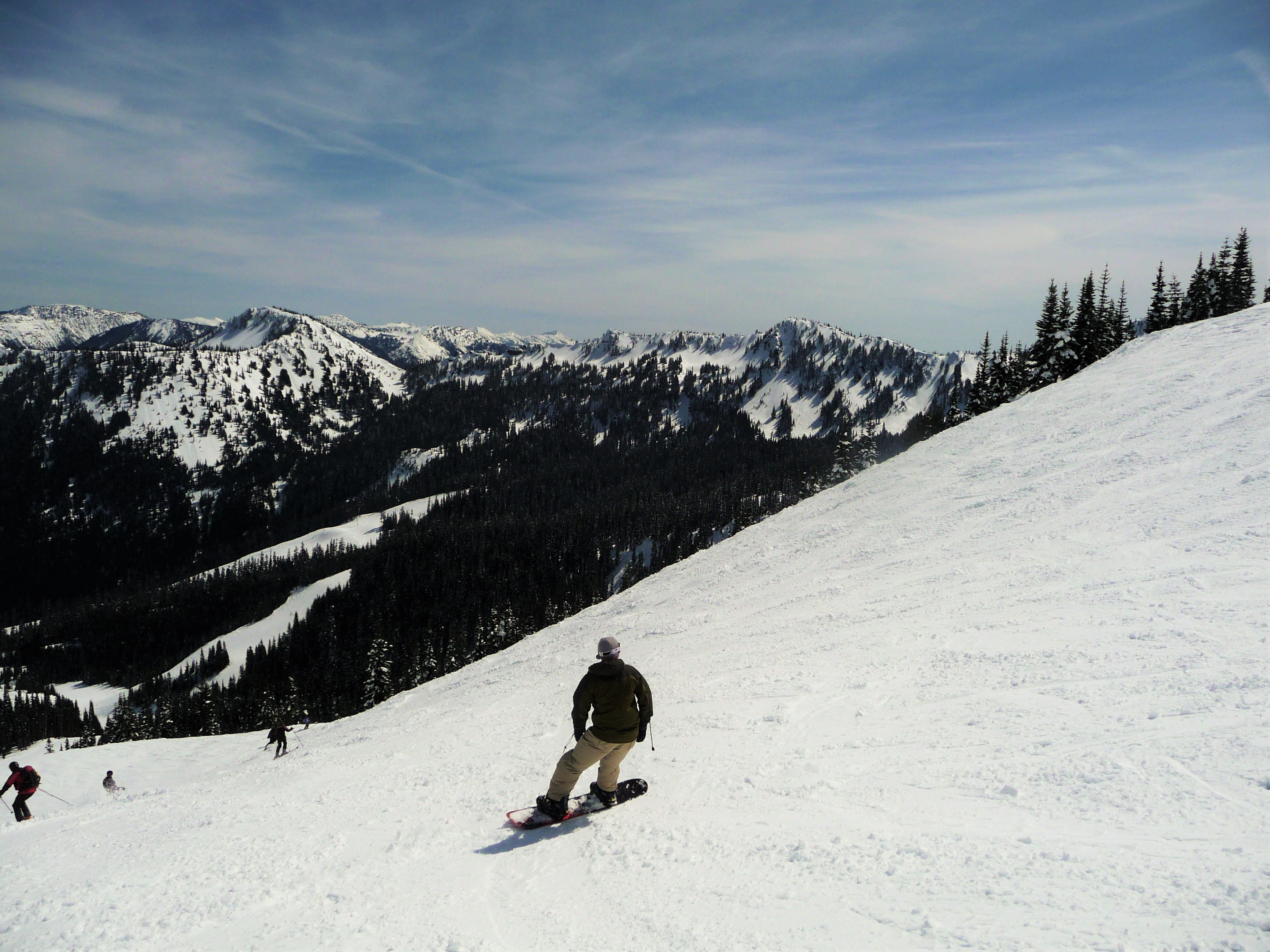 Boarder and Skiers on Crystal Mountain, photo by Matt Zimmerman via Flickr Creative Commons