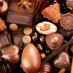 Chocolates background. Chocolate. Assortment of fine chocolates in white, dark, and milk chocolate. Praline Chocolate sweets