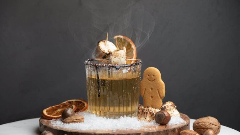 apple cider cocktail with gingerbread man